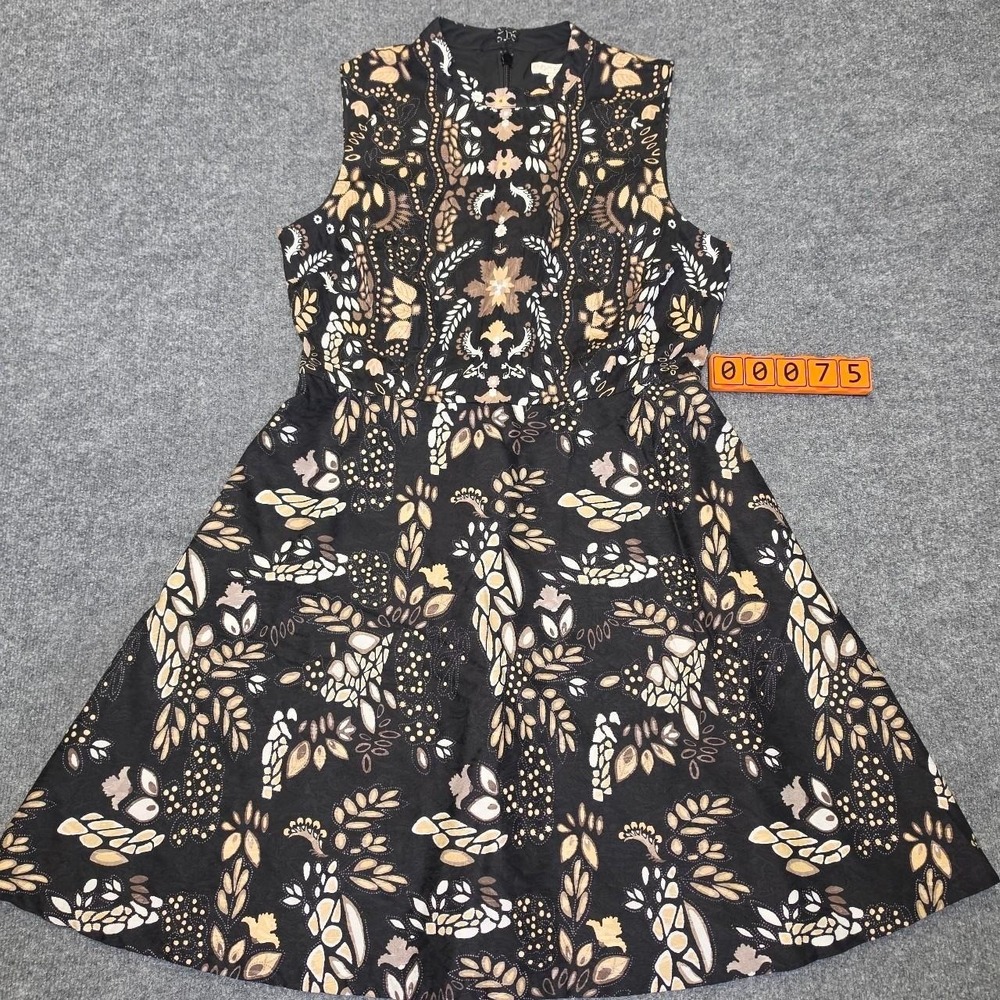 Eva Mendes black dress with beige and white  motifs, with pockets, size 12.